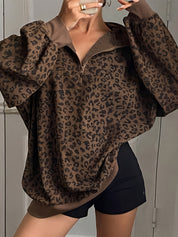 Oversized leopard print quarter zip sweatshirt in brown, worn open at the collar