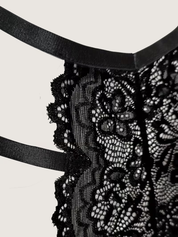 Macro detail of the scalloped floral lace and satin strap edging