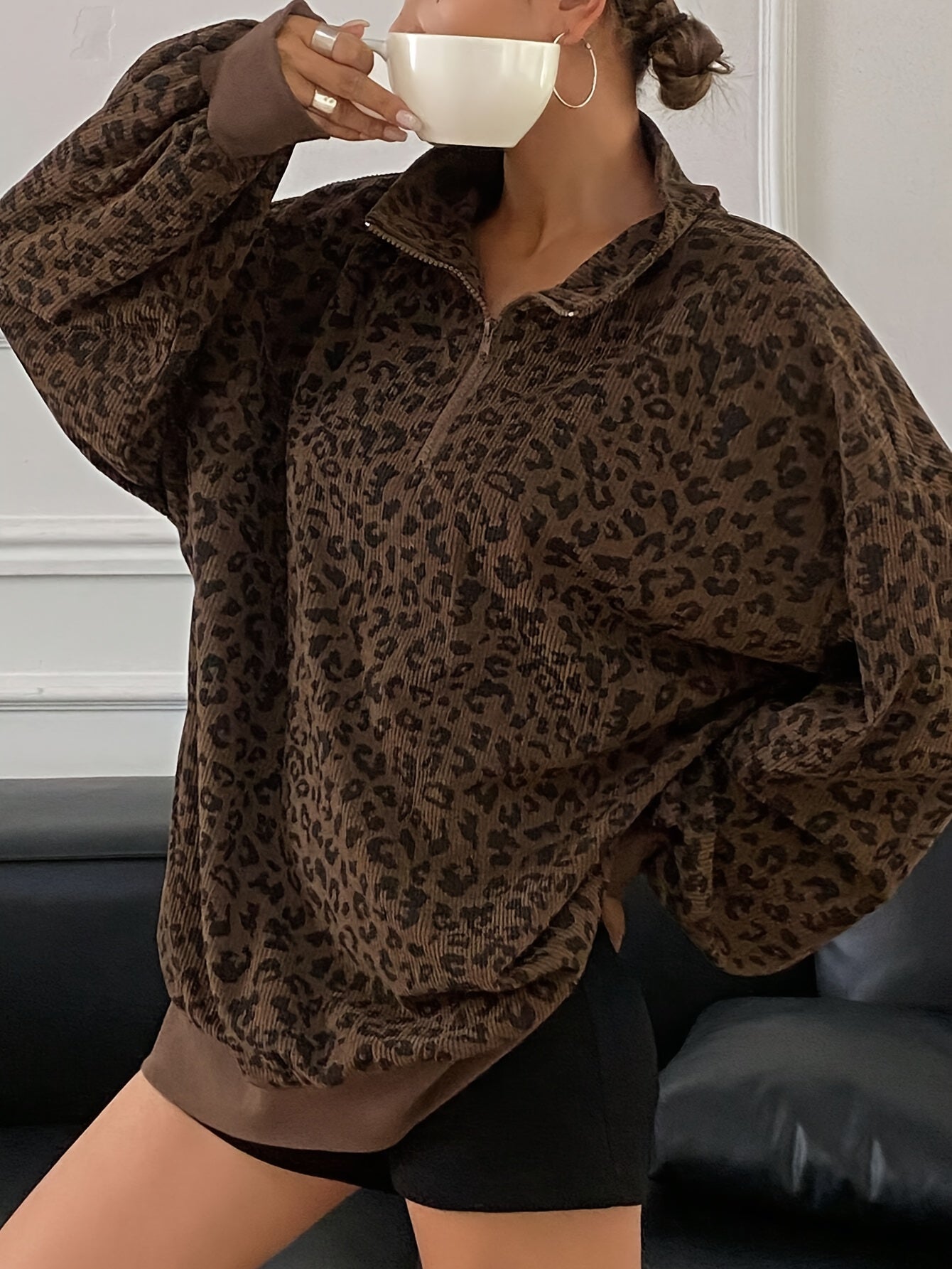 Brown leopard quarter zip sweatshirt showing the funnel collar and ribbed cuffs