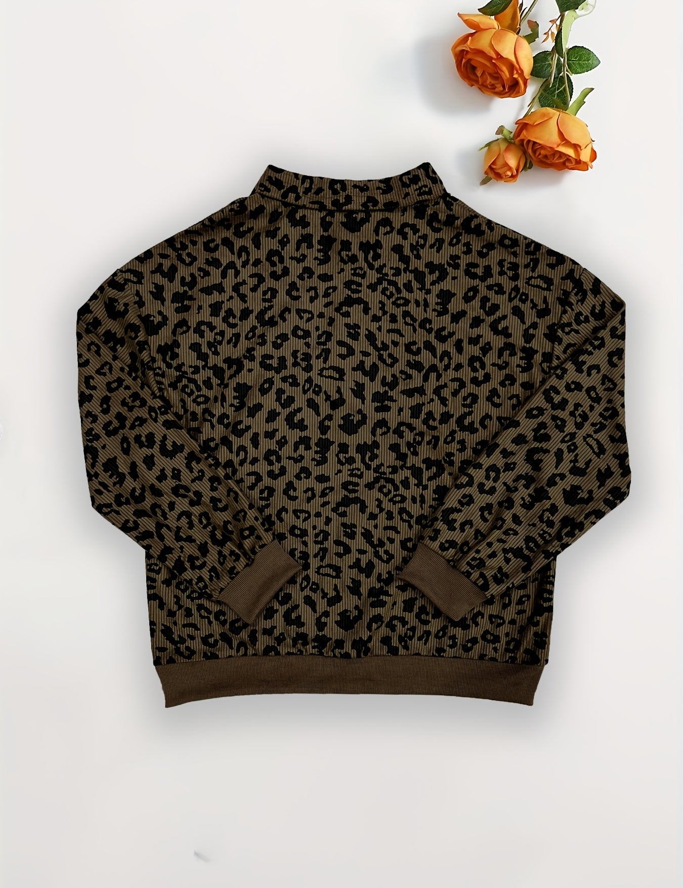 Brown leopard quarter zip sweatshirt laid flat showing the full oversized cut and ribbed hem