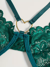 Gold-tone heart ring hardware detail on the emerald lace bodysuit
